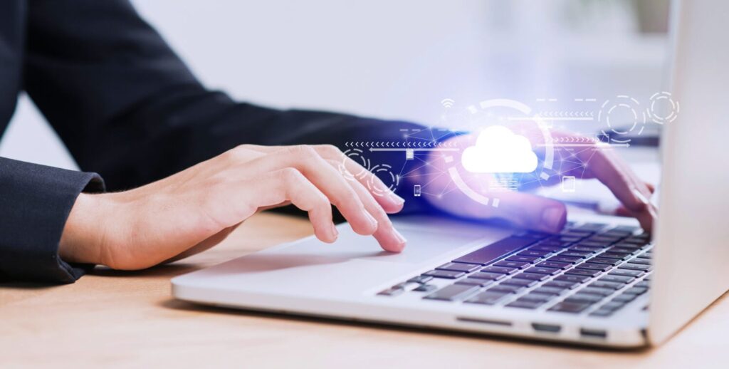 woman working on multi-cloud databases with her laptop