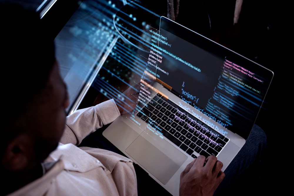 Backend developer writing code on his laptop