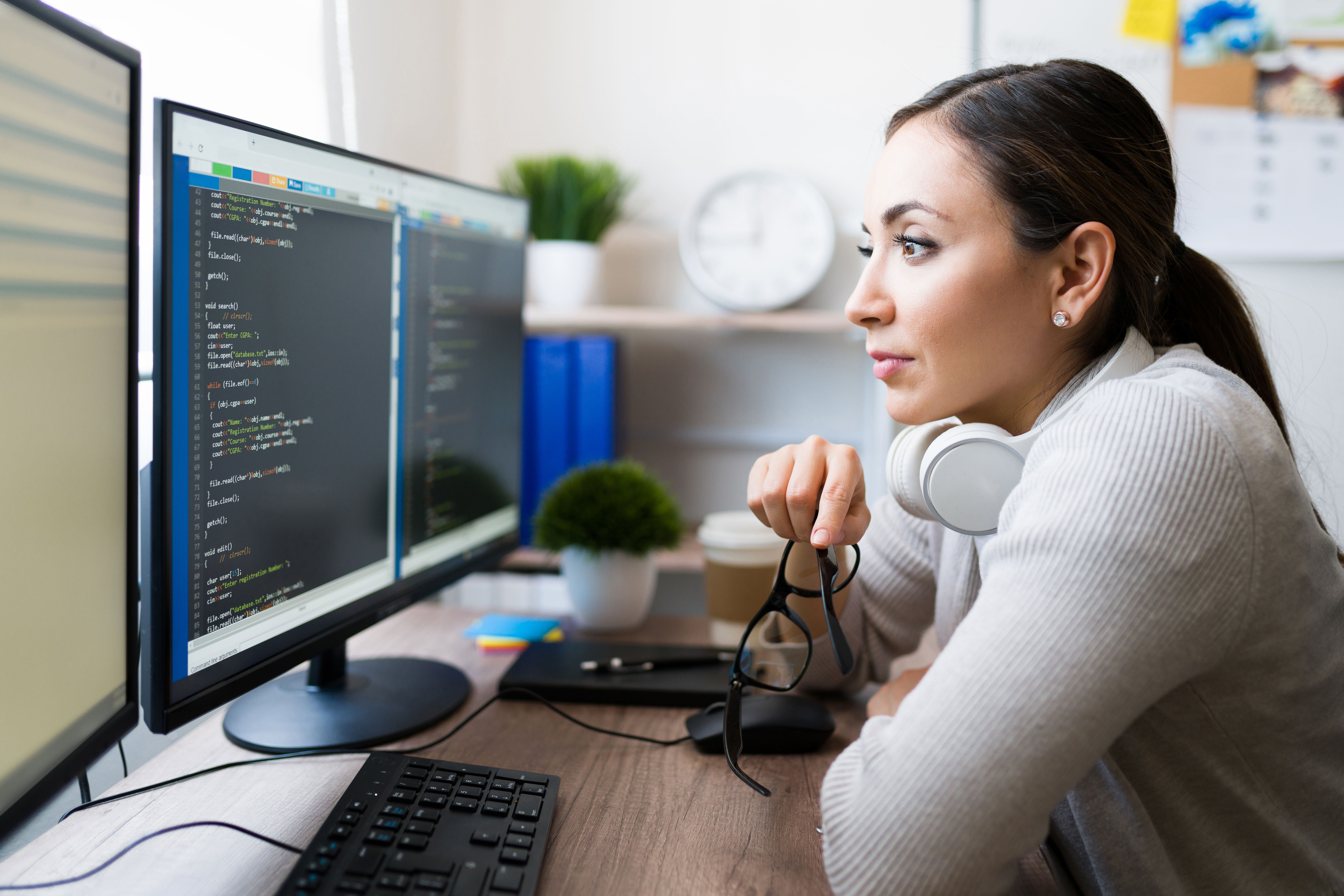 Woman using android studio tools to help with her code on her computer