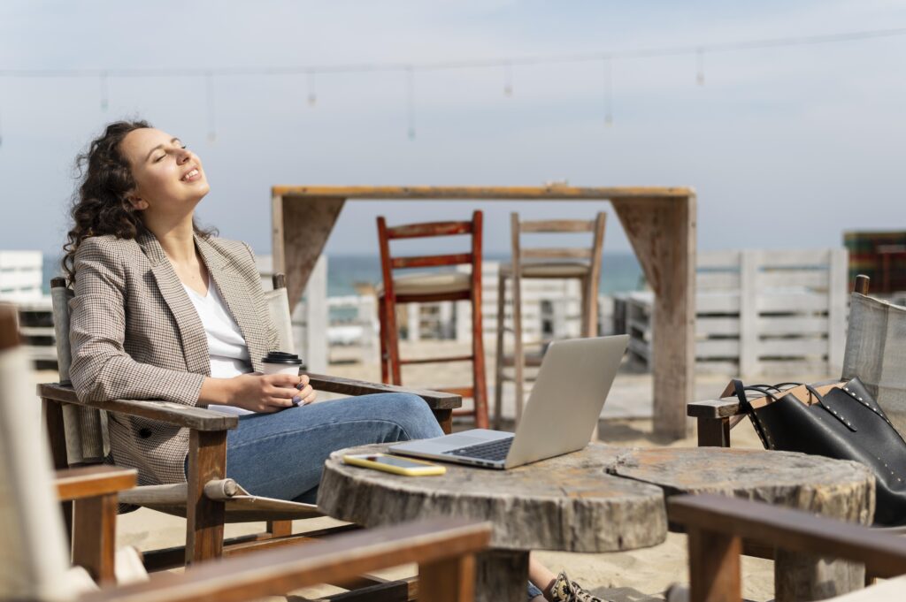 woman enjoying her remote work job at the beach