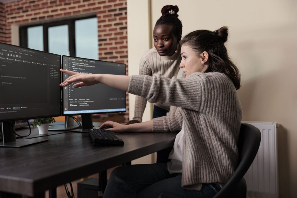 Two devops developers working with their computers