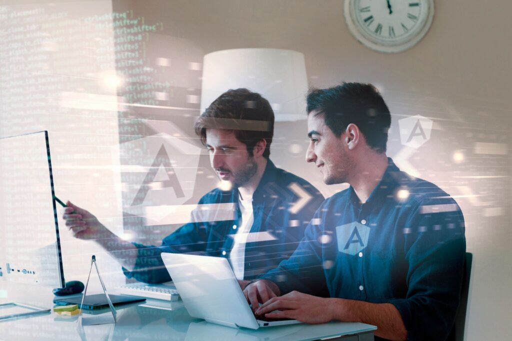 Two developers working on angular development with their laptops